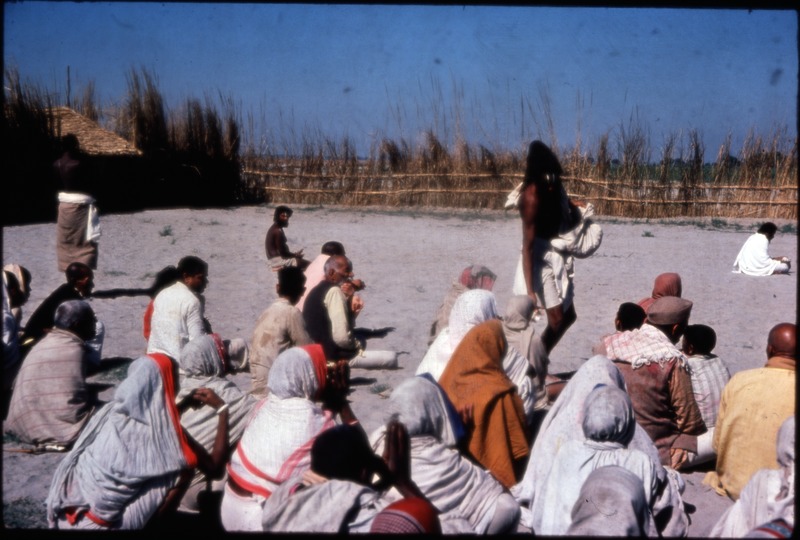 Distribution of prasād (batāsā) by one of Deoria Baba's disciples