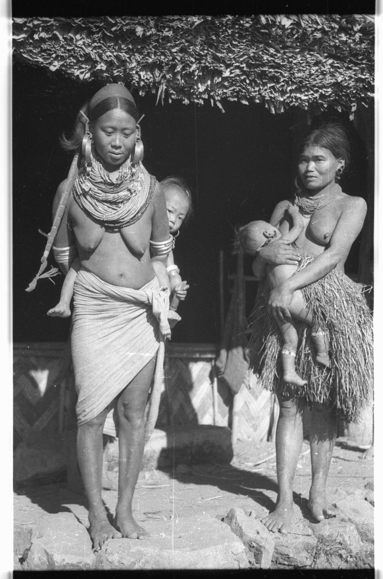 Ang's wife Likau carrying a child on her back - 