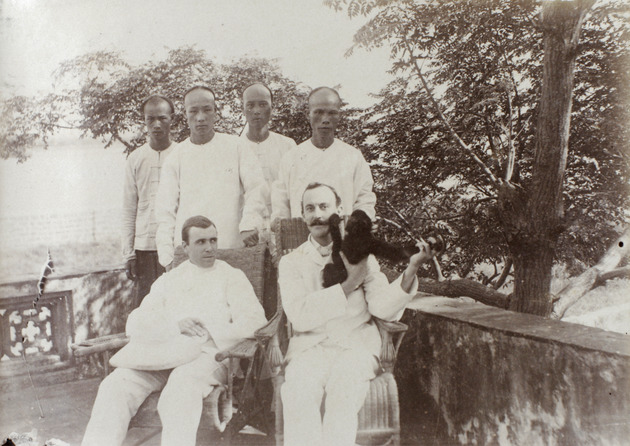 Photograph, R.F.C. Hedgeland with E. H. de St. Croix, servants and 'Jacko' (a monkey), Hoihow [Hǎikǒu] - 