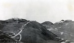 Photograph, hills topped with mansions, some terracing and paths