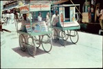 Two kulfÄ« (ice-cream) sellers with their barrows in LoÄ« Bazaar