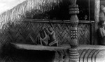 Carved wooden figures in front of a Morung (Image number C.022, J.P. Mills Photographic Collection)
