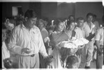 Row of people with offerings during mass